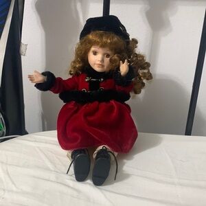 A porcelain doll with brown Curley hair that makes noises when moved and turned